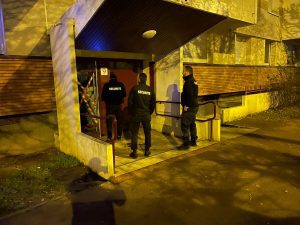 Trois agents de sécurité bailleurs sociaux nuit devant un immeuble